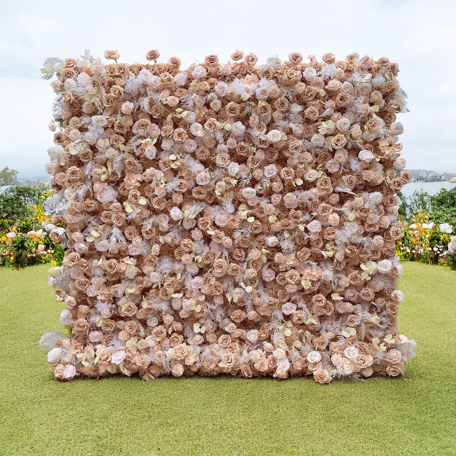 A luxurious ValarFlowers nude floral wall featuring lifelike blush roses, champagne blooms, and frosted fern accents. Perfect for weddings or events, it creates an elegant, timeless backdrop for stunning photos.