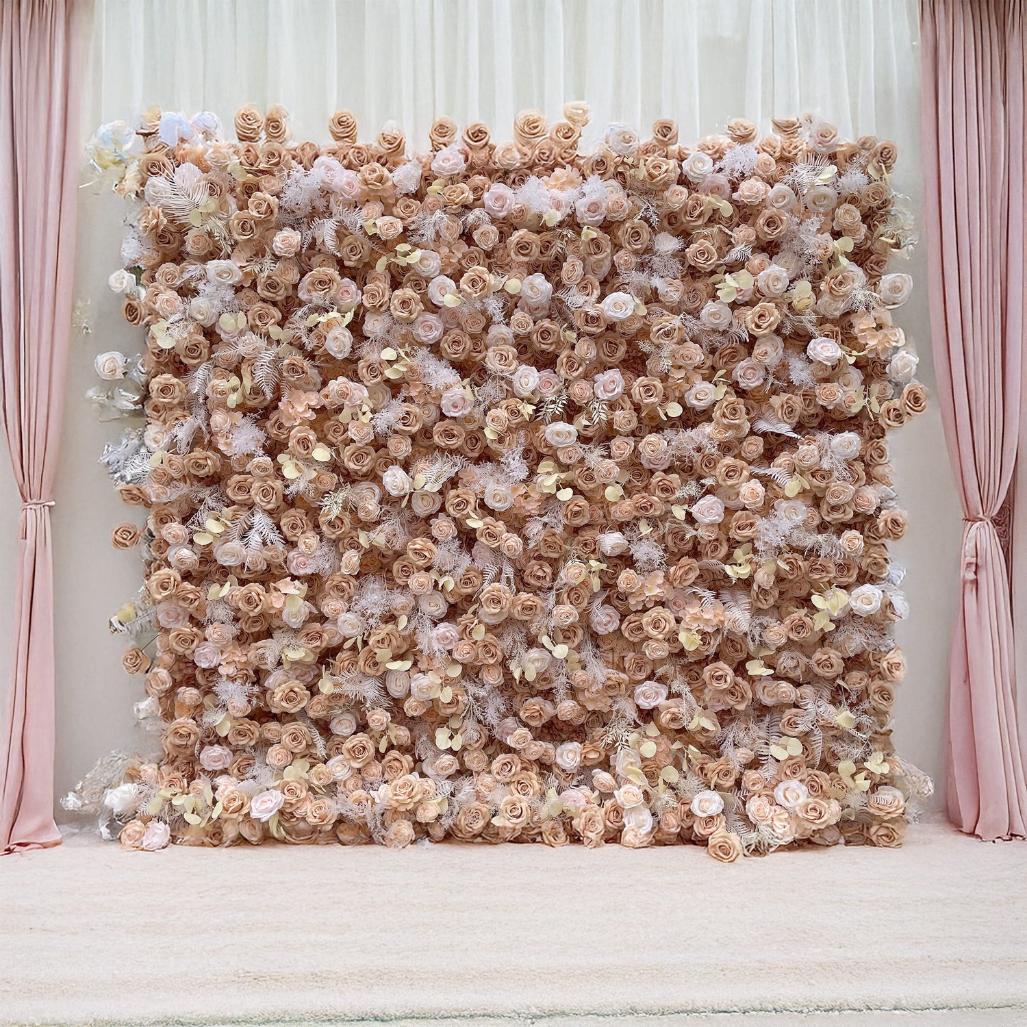 This ValarFlowers floral wall display features a luxurious arrangement of beige, blush, and ivory roses accented by soft ferns. Set between elegant pink drapes, it creates a sophisticated event backdrop.