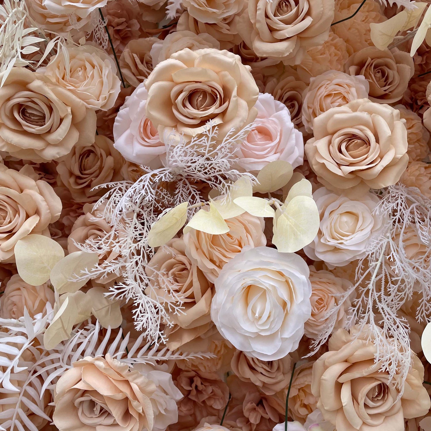 This image from ValarFlowers captures a luxurious floral arrangement featuring soft beige and blush roses accented with delicate white foliage and cream petals, creating an elegant and romantic aesthetic.