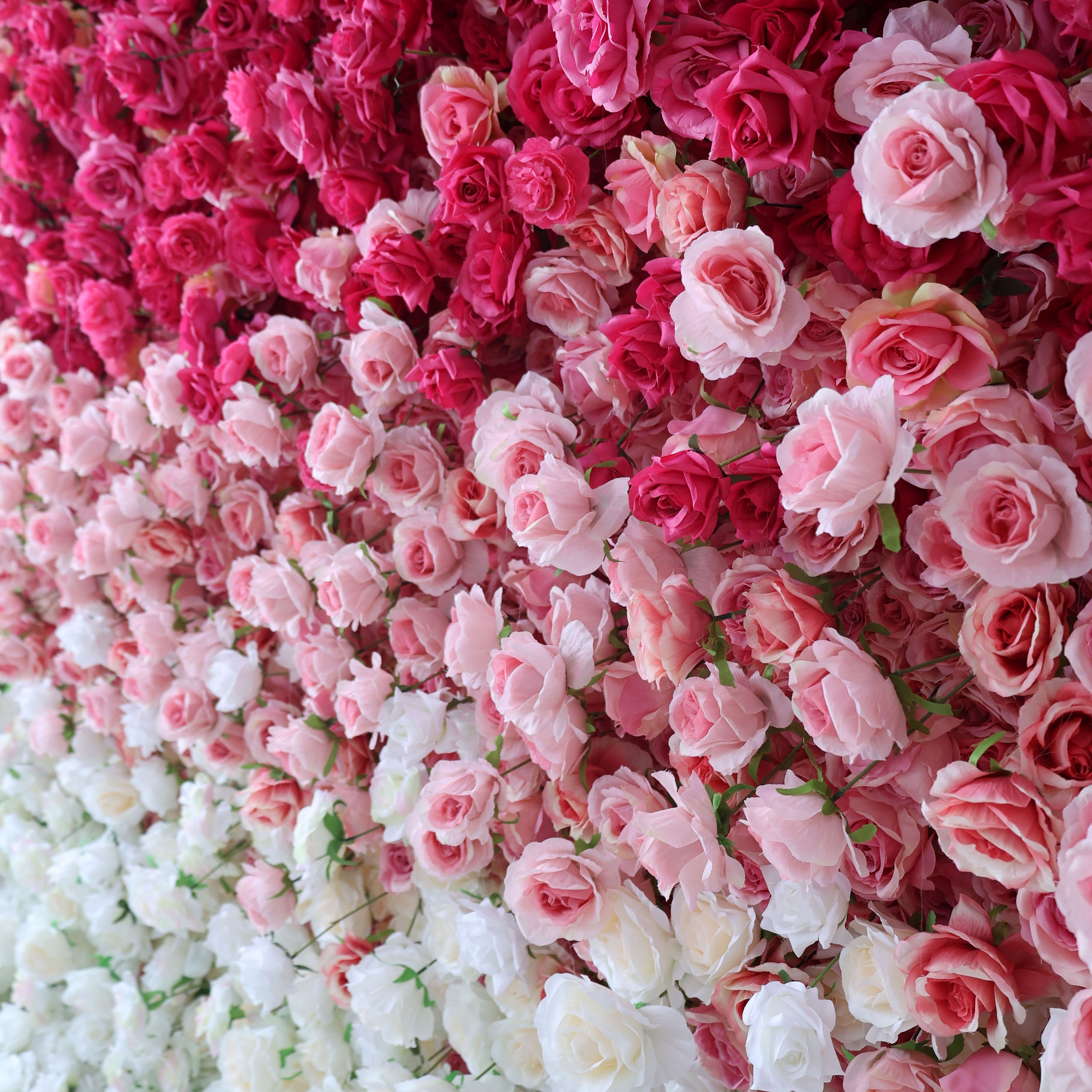 This artificial flower wall features a stunning gradient of pink to white roses. It is likely easy to install, durable, and suitable for various events such as weddings and parties. The flowers are densely packed, creating a lush and romantic appearance.