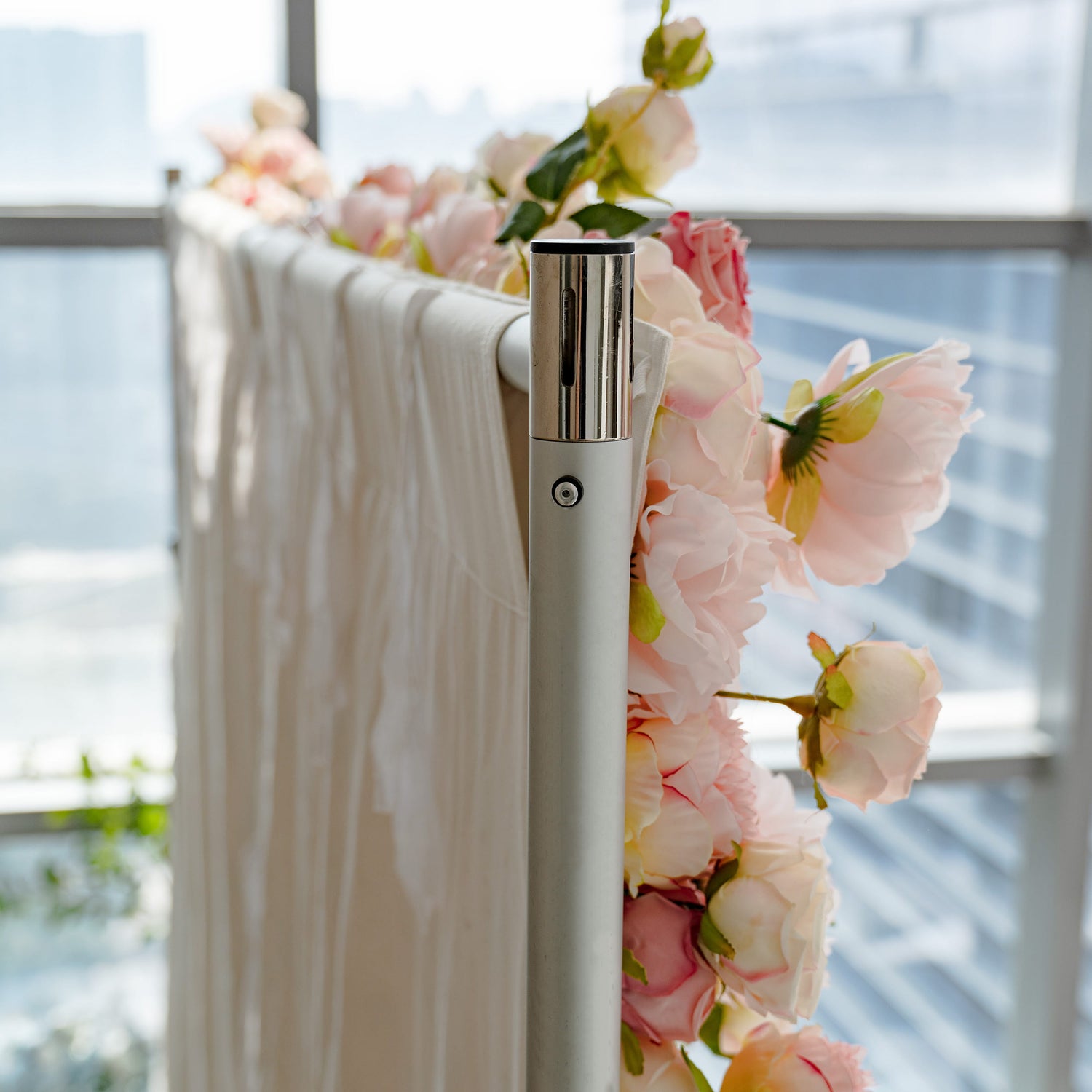 A close - up of a flower - adorned structure. The flowers are neatly arranged, showing excellent craftsmanship. The metal stand is sturdy and well - made.