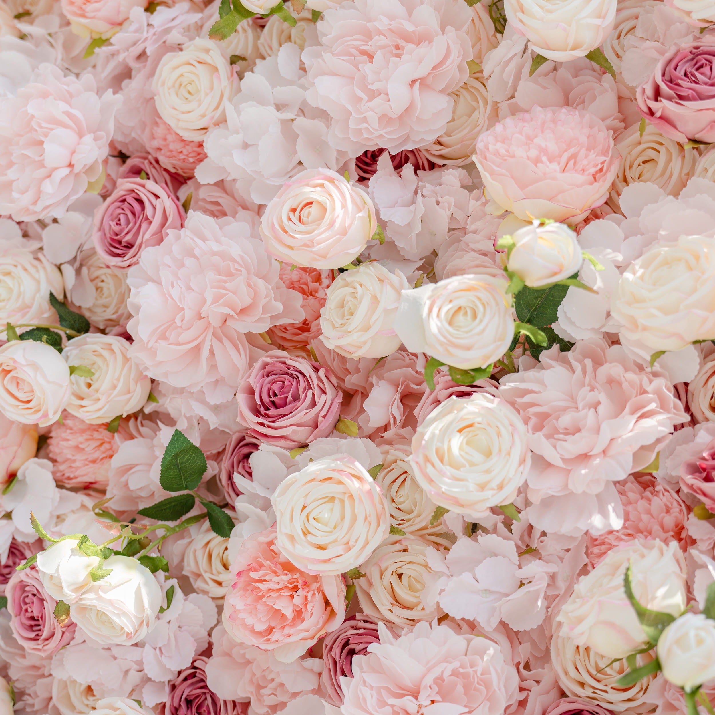 A close - up of a collection of artificial flowers. The arrangement features various shades of pink and white roses and peonies, creating a soft and romantic floral display.