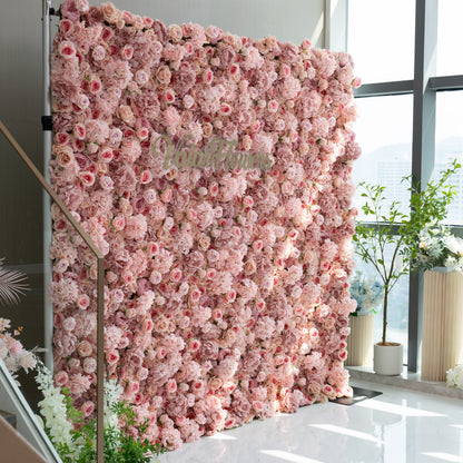 This image features a stunning floral wall adorned with a dense arrangement of light pink and peach - colored flowers. The wall is part of a display that includes the brand name &quot;ValarFlowers&quot; prominently displayed in the center. The overall ambiance is soft, romantic, and inviting, making it ideal for events such as weddings, bridal showers, or romantic celebrations.