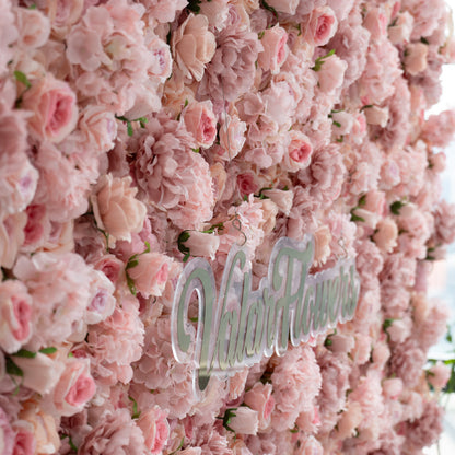 The image features a lush, pink floral wall with the text &quot;ValarFlowers&quot; prominently displayed in the center. The flowers are densely packed, creating a soft and romantic backdrop.