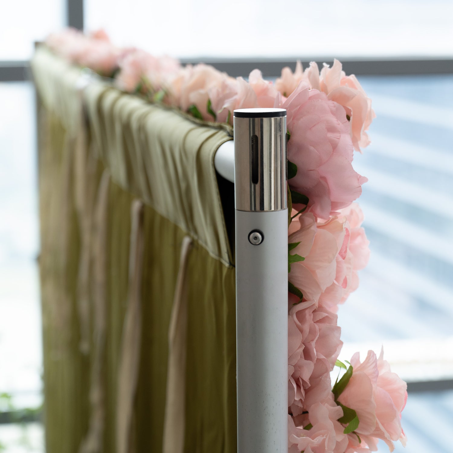 The image shows a section of a high - quality cloth backing adorned with a beautiful arrangement of large, soft - pink flowers. The cloth appears to be sturdy and well - made, providing a luxurious backdrop for the floral decoration. The flowers are densely packed, creating a lush and elegant display.