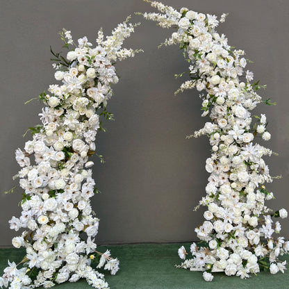 Stunning artificial floral arch for weddings, ceremonies, and special events. Features all-white flowers (roses, lilies, peonies, daisies) with green foliage, arranged in a cascading effect on a sturdy frame. Ideal for indoor/outdoor use. Pure, elegant design enhances any setting.