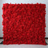 A luxurious ValarFlowers red artificial flower wall, featuring vibrant silk roses and hydrangeas densely packed on a fabric base. Perfect for elegant event decor, weddings, and Instagram-worthy backdrops.