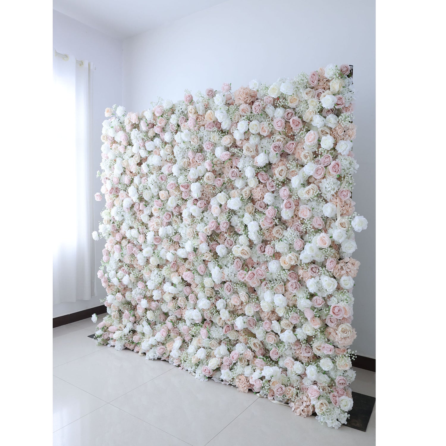 Exquisite artificial flower wall backdrop featuring a blend of white, blush, and trendy nude roses with delicate filler flowers. Perfect for weddings, ceremonies, and events. Realistic, high-quality materials on a sturdy frame. Ideal for photo backdrops and decor. Easy to set up and enhances event ambiance.