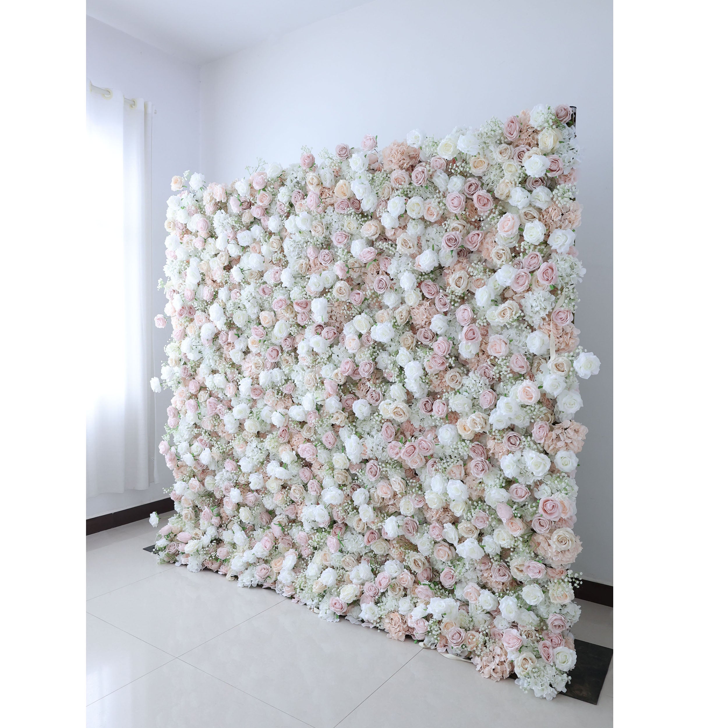 Exquisite artificial flower wall backdrop featuring a blend of white, blush, and trendy nude roses with delicate filler flowers. Perfect for weddings, ceremonies, and events. Realistic, high-quality materials on a sturdy frame. Ideal for photo backdrops and decor. Easy to set up and enhances event ambiance.